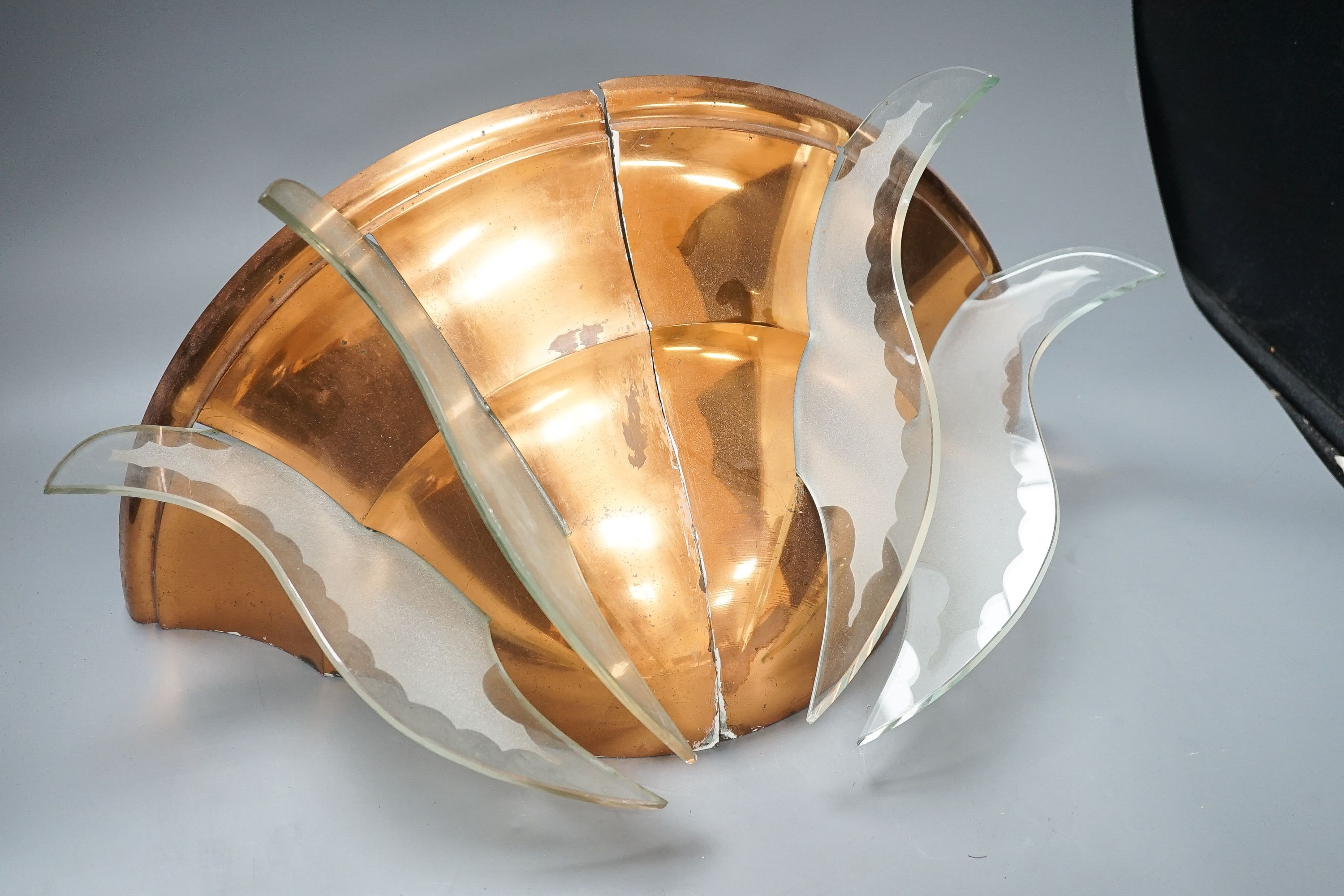 A pair of copper quarter wall lights